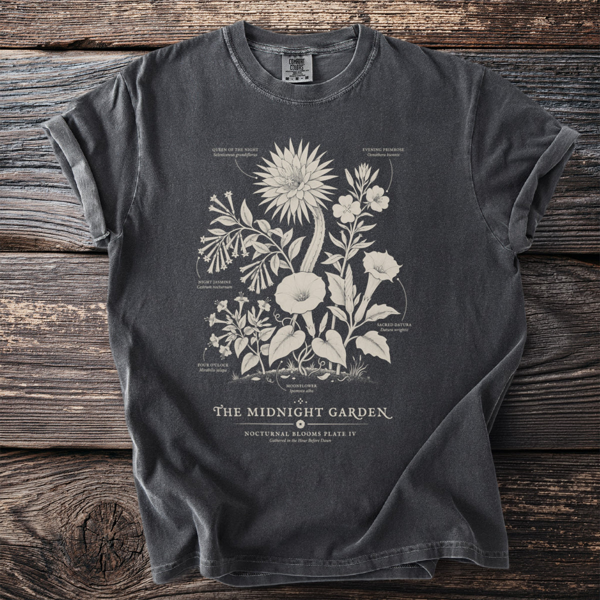 Dark grey t-shirt with "The Midnight Garden" botanical print and text.