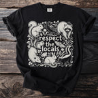 Black t-shirt with "respect the locals" and illustrated animals: squirrel, raccoon, skunk, opossum, rabbit, snake, frog, moth, and crow.