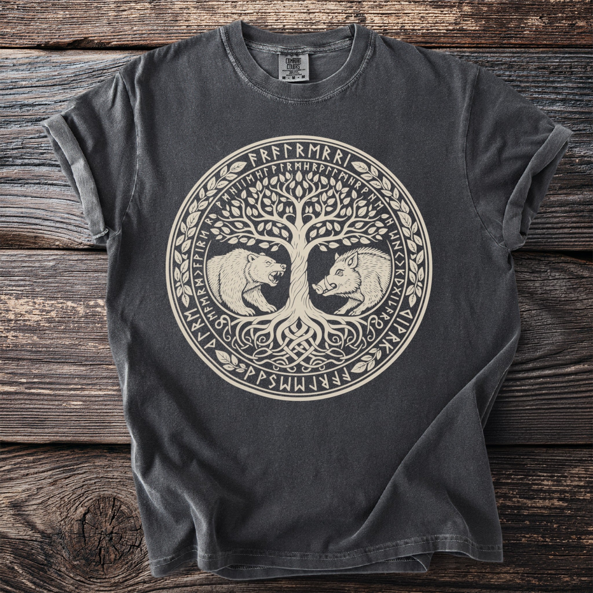 Dark t-shirt with a circular Norse-inspired design featuring a tree, bear, boar, and runes.