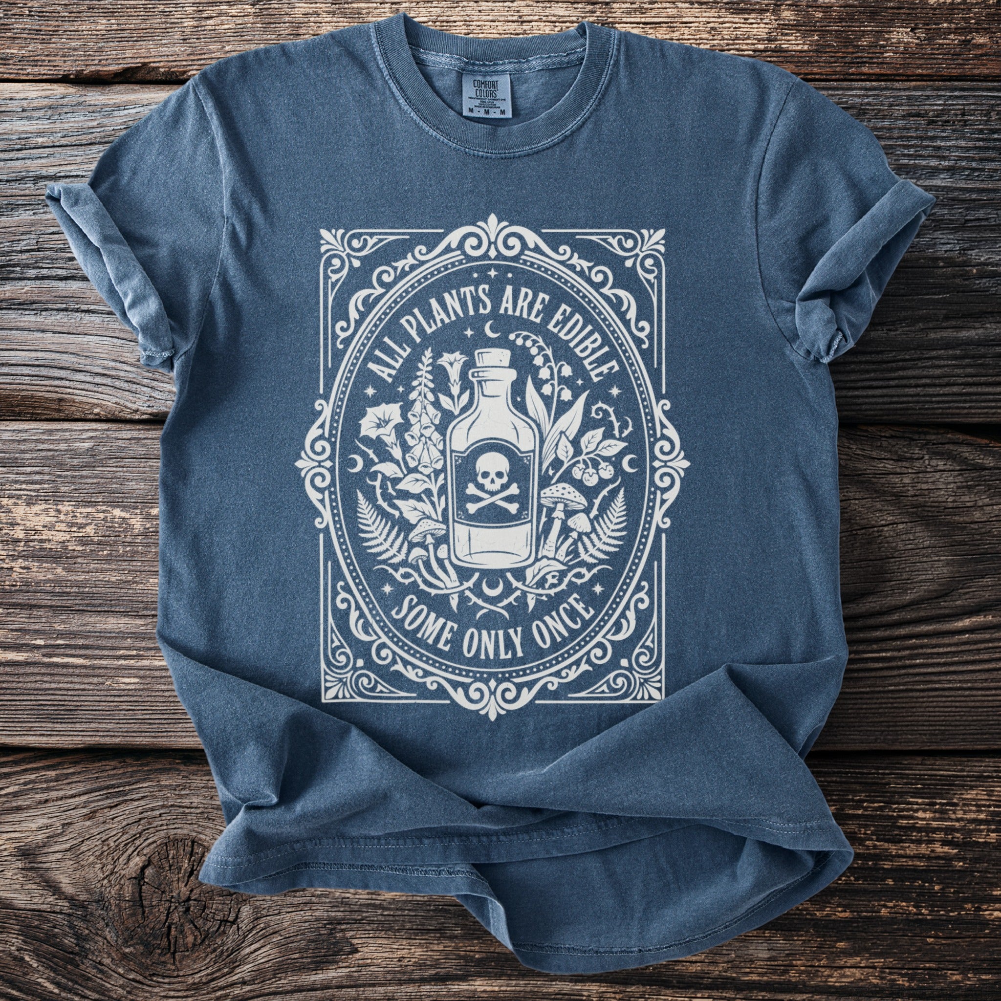 Blue t-shirt with white graphic: "All Plants Are Edible Some Only Once".
