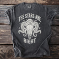 Dark grey t-shirt with white graphic of ram skull, flower, and text "The Stars Are Right".