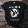Black t-shirt with white graphic of Jersey Devil flying over pine trees under a moon.