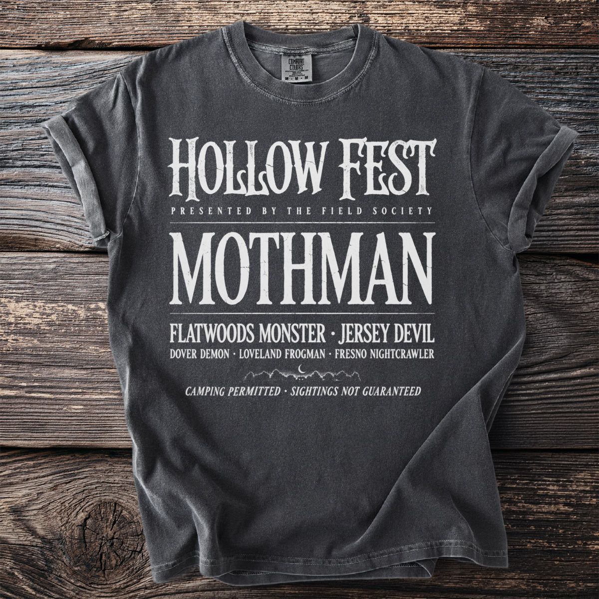 Dark t-shirt with "Hollow Fest" and "Mothman" text, listing other cryptids.