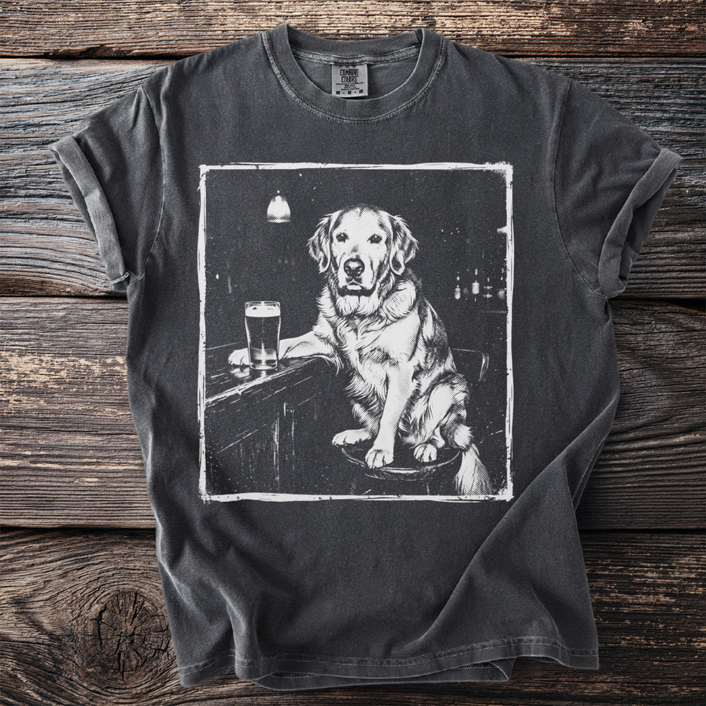 T-shirt with a graphic print of a golden retriever sitting at a bar with a beer.