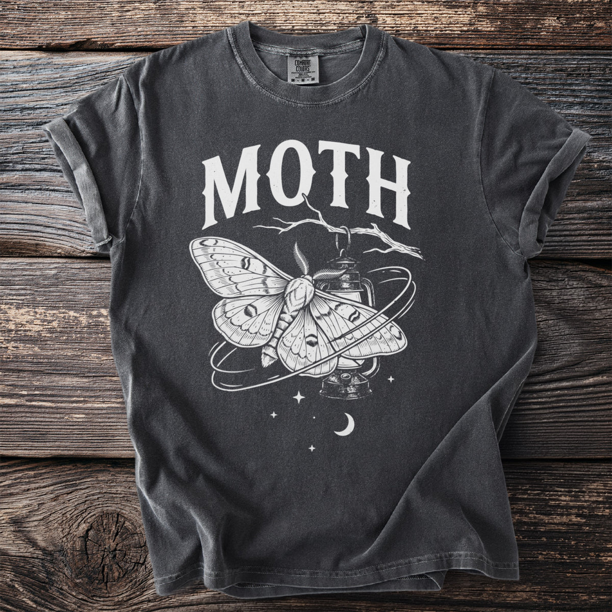 Dark grey t-shirt with white moth and lantern graphic and text "MOTH".