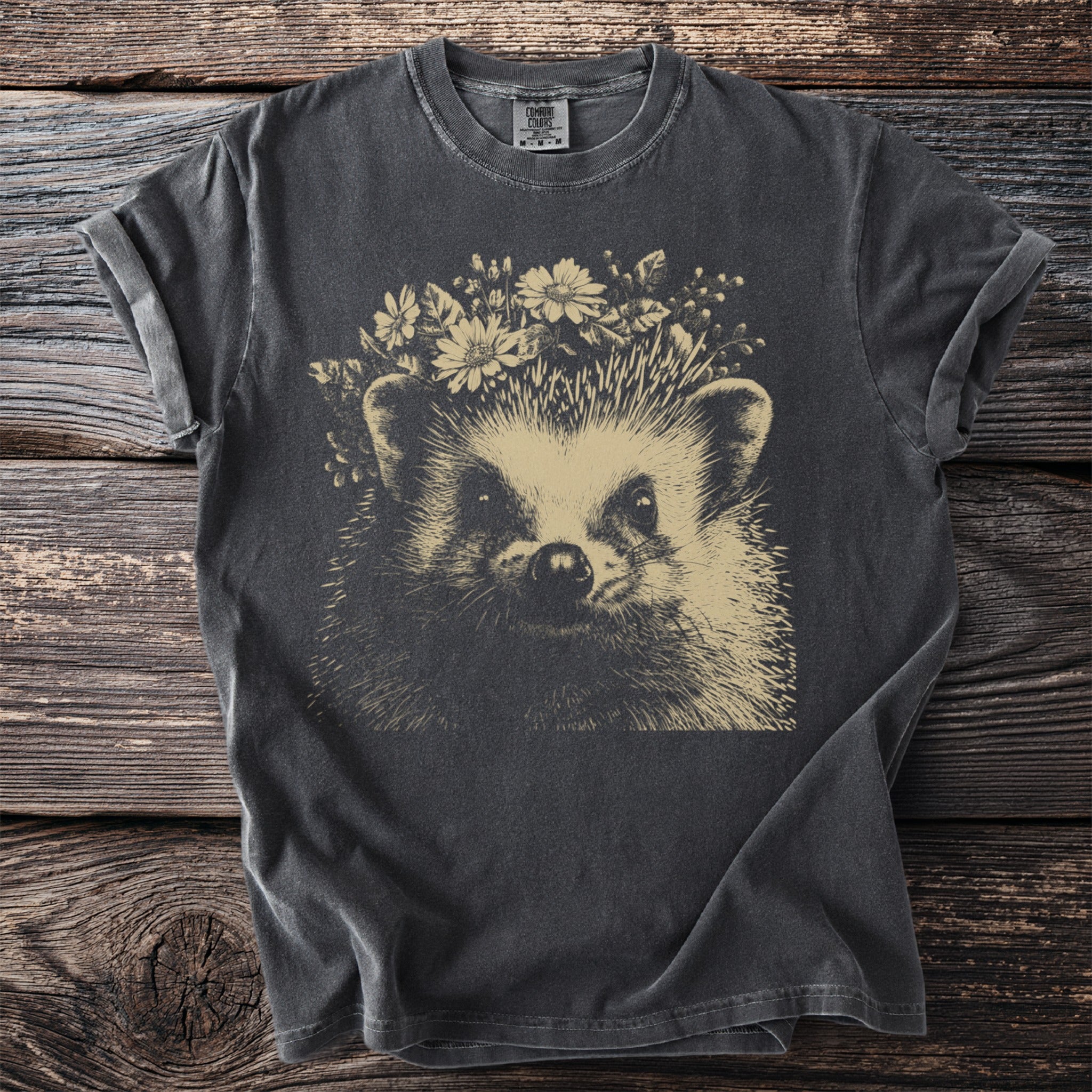 Dark gray t-shirt with a tan graphic of a hedgehog wearing a flower crown.