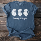 Blue t-shirt with three white ghosts, one holding a skull, text "Spooky & Bright".