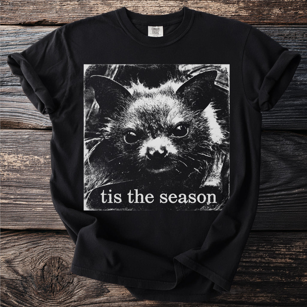 Black t-shirt with grunge style graphic of a bat face and text "tis the season".