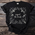 Black t-shirt with white line art of dragonflies and plants, reads "respect the locals".