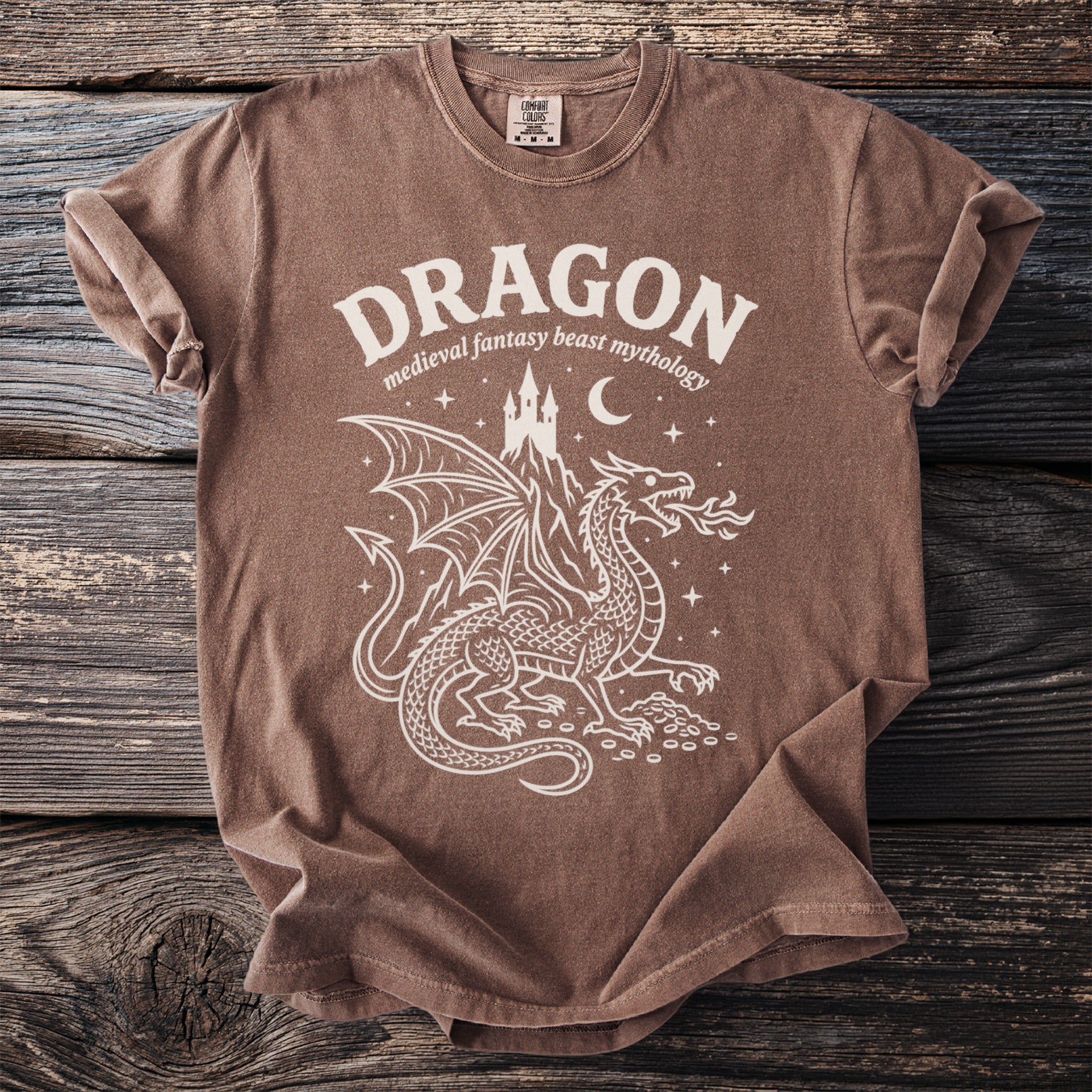 Brown t-shirt with white dragon design and text "DRAGON medieval fantasy beast mythology".