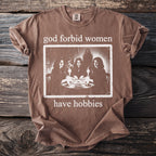 Brown t-shirt with white text and an image of women using an Ouija board.