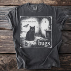 Black t-shirt with graphic of cat, moth, spider, and text "you're not alone there are bugs".