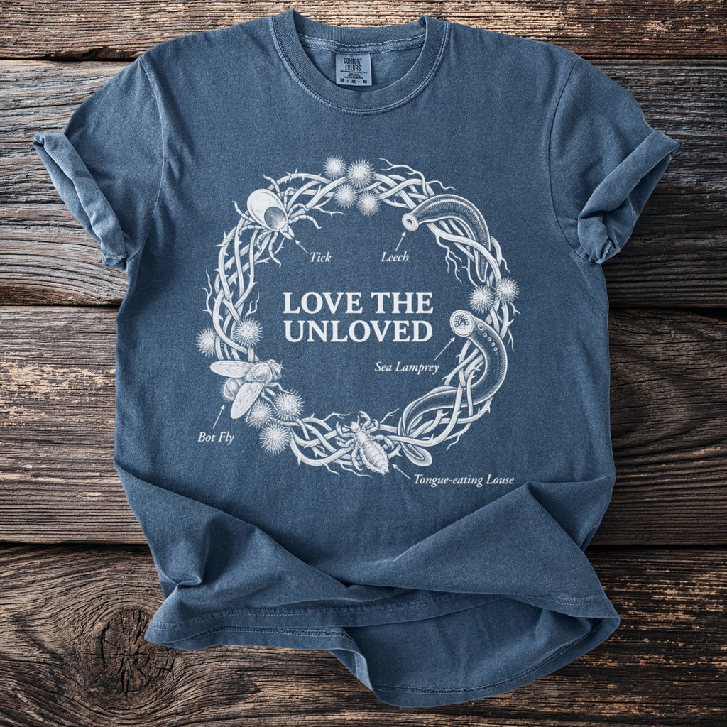 Blue t-shirt with "Love the Unloved" text and illustrations of ticks and leeches.
