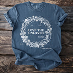Blue t-shirt with "Love the Unloved" text and illustrations of ticks and leeches.