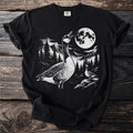 Black t-shirt with a graphic of two geese at night with a moon and mountains.