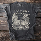 Dark grey t-shirt with the Comfort Colors tag. The graphic features a black cat, an open book, a quill, a candle, and mushrooms.