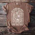 Brown t-shirt with white text and skull graphic: "All plants are edible, some only once."