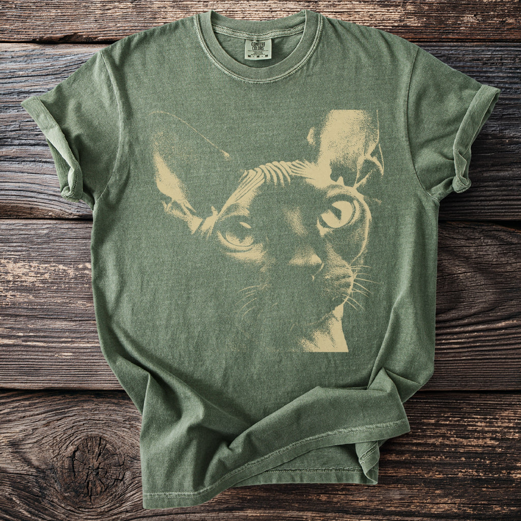 Green t-shirt with a light beige Sphinx cat illustration centered on the front.