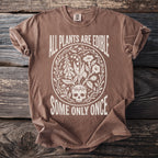 Brown t-shirt with white text and graphic including skull and plants.