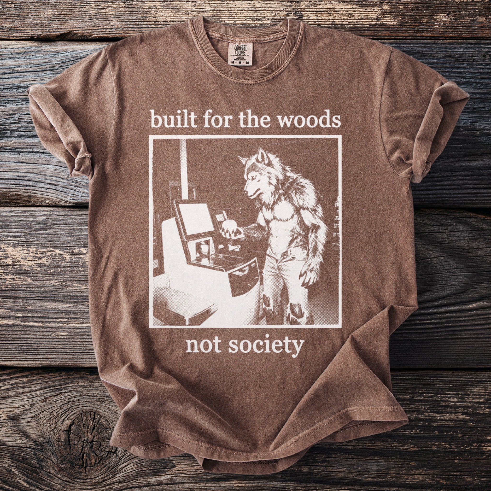 Brown t-shirt with wolfman at computer graphic and text "built for the woods not society."
