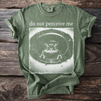 Green t-shirt with "do not perceive me" and a distressed frog graphic.