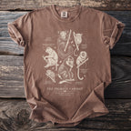 Brown t-shirt with "The Primate Cabinet" and illustrations of various primates.