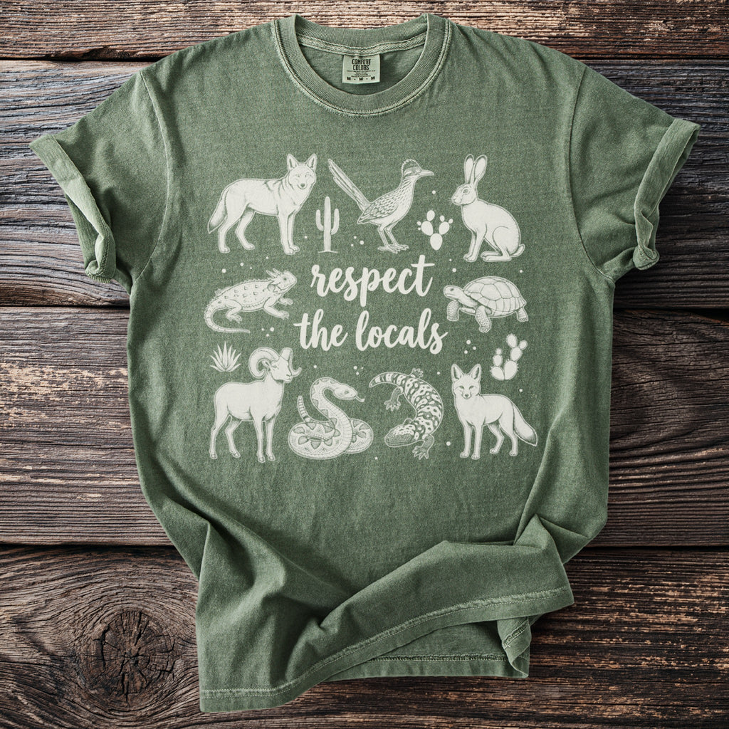 Green t-shirt with white desert animals and "respect the locals" text.