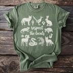 Green t-shirt with white desert animals and "respect the locals" text.