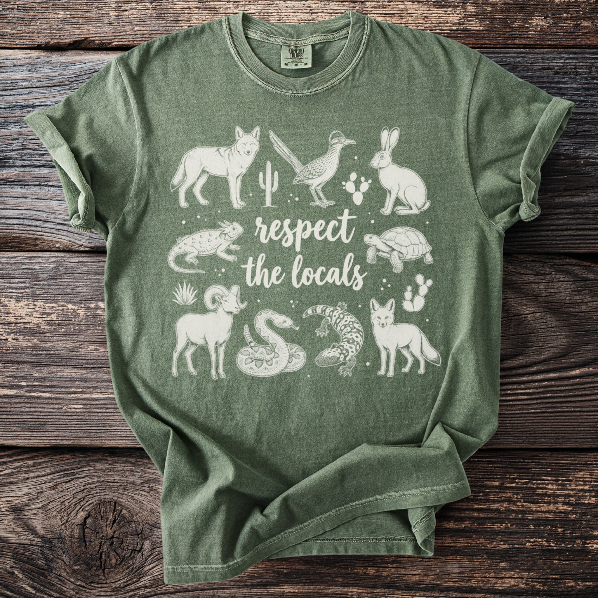 Green t-shirt with white desert animals and "respect the locals" text.