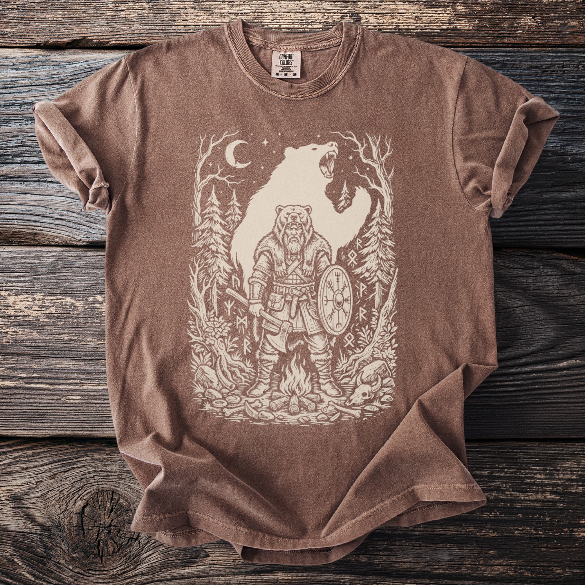 Brown t-shirt with a line art design of a Viking warrior and a bear in a forest.