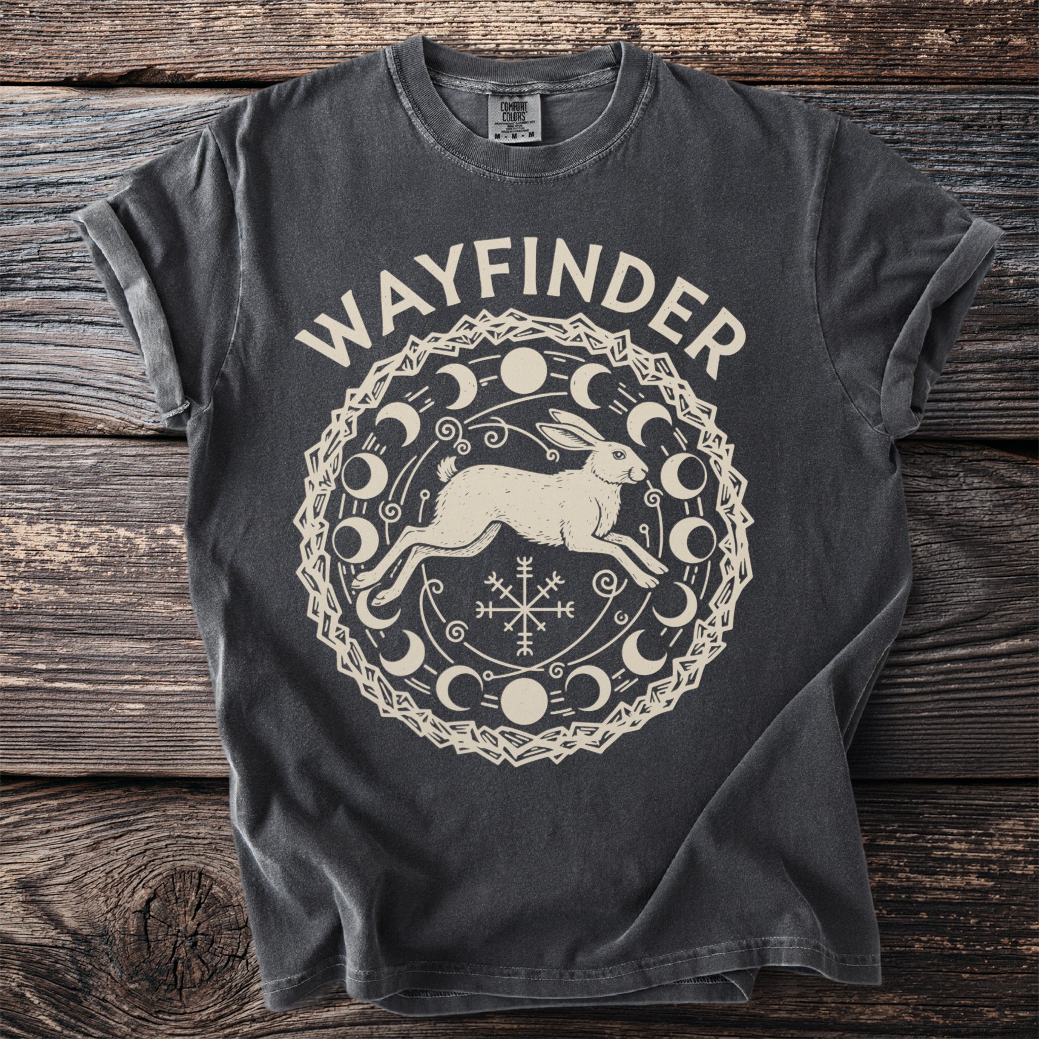 Dark gray t-shirt with "WAYFINDER" and a graphic of a running hare within a moon phase mandala.