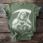 Green t-shirt with Grim Reaper making a heart symbol with skeleton hands.