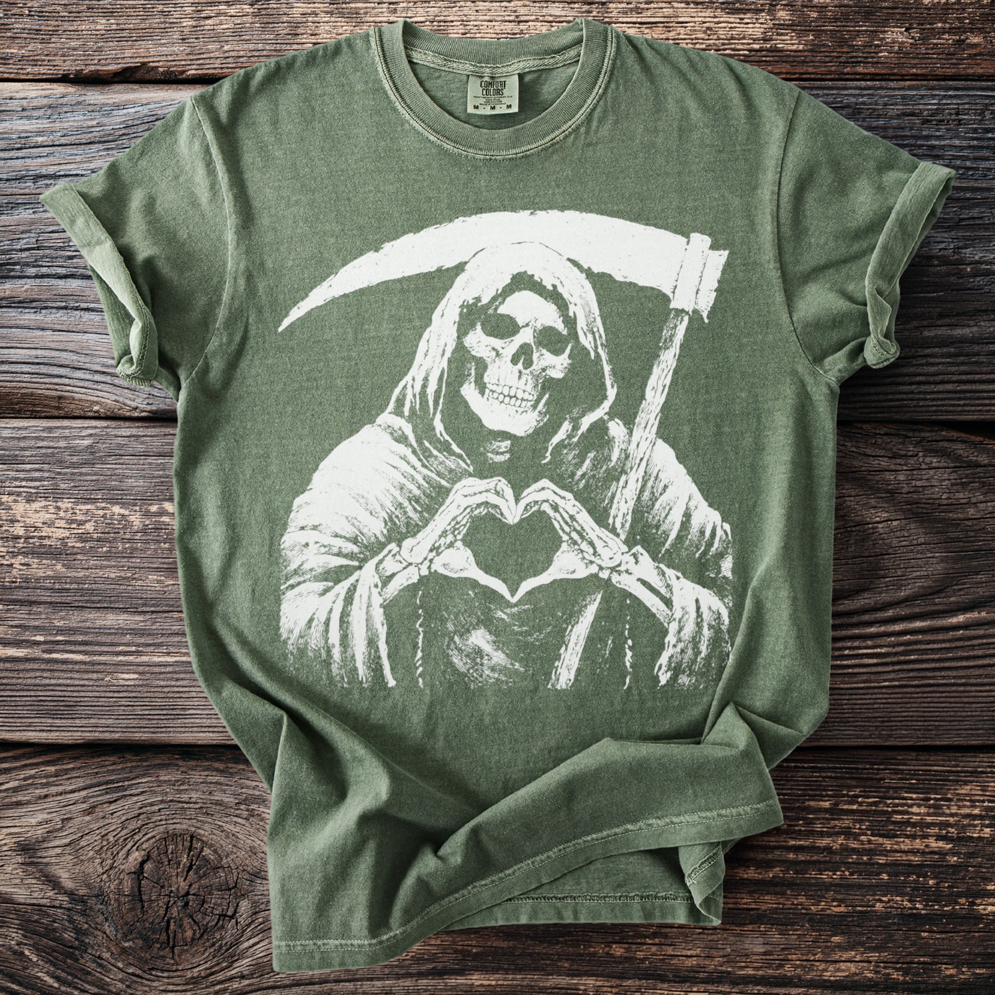Green t-shirt with Grim Reaper making a heart symbol with skeleton hands.