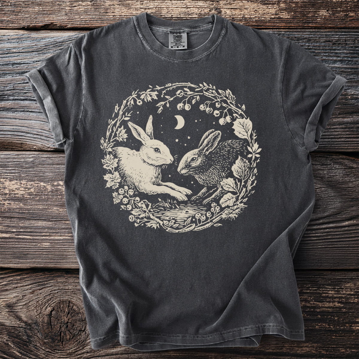Dark gray t-shirt with a circular graphic of two rabbits among branches and a crescent moon.