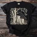 Black t-shirt with a linocut-style print of a raven on tree stumps.