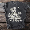 T-shirt with cream graphic of woman with flowing hair by lighthouse under moon