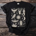 Black t-shirt with cream-colored celestial and nature-themed illustrations.
