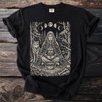 Black t-shirt with a black and white print of a meditating woman, wolf, raven, moons, runes, and bones.