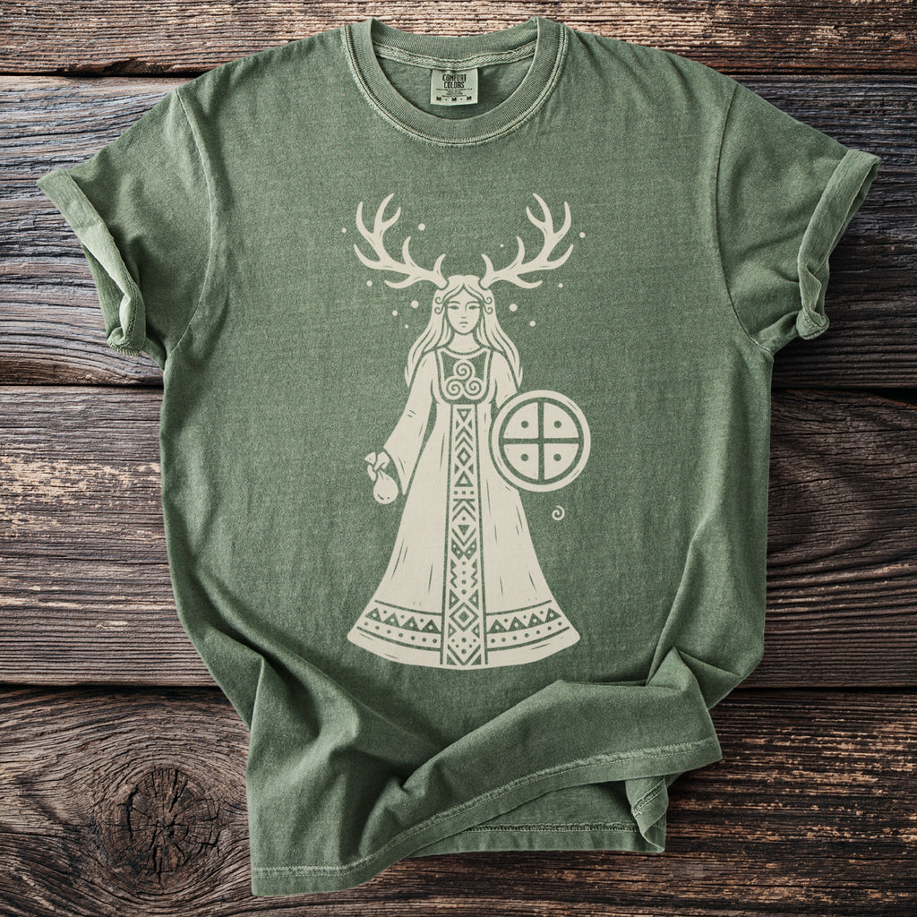 Green t-shirt with a cream graphic of a woman with antlers holding a shield.