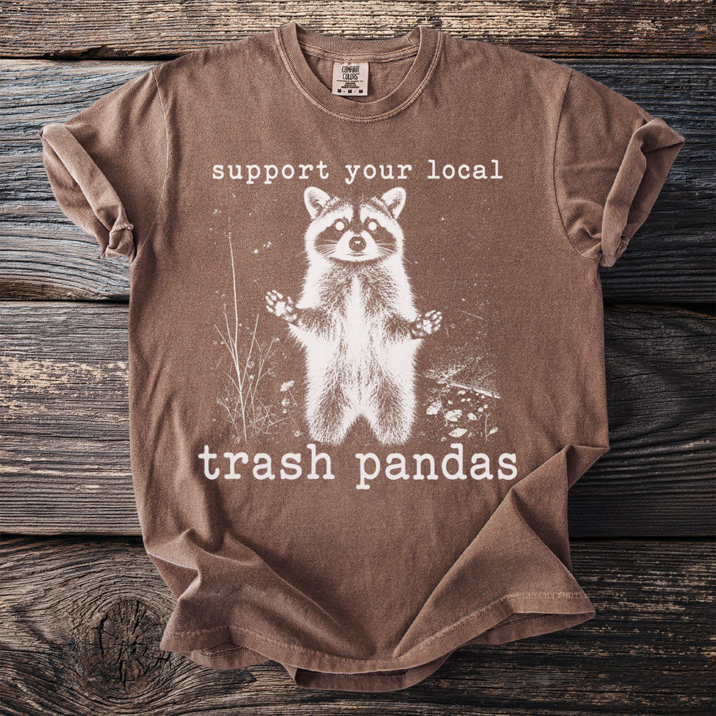 Brown t-shirt with graphic of raccoon and text "support your local trash pandas".