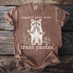Brown t-shirt with graphic of raccoon and text "support your local trash pandas".