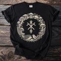 Black t-shirt with a beige circular design of mushrooms, ferns, a hedgehog, and a bird.