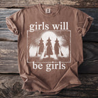 Brown t-shirt with "girls will be girls" text and three witch silhouettes.