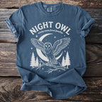 Blue t-shirt with a white graphic of a night owl, moon, and trees.