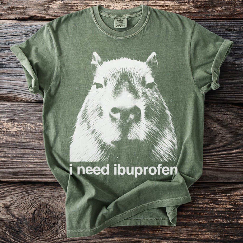 Green t-shirt with distressed white capybara graphic and text "i need ibuprofen".