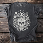 Dark t-shirt with cream skull, moth, crescent moon, and floral design.