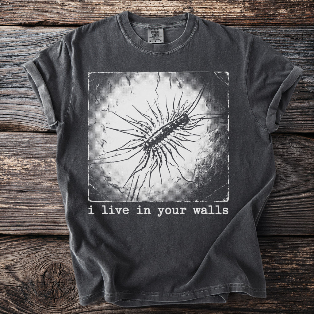 Dark grey t-shirt with a black and white graphic of a centipede and the text "i live in your walls."