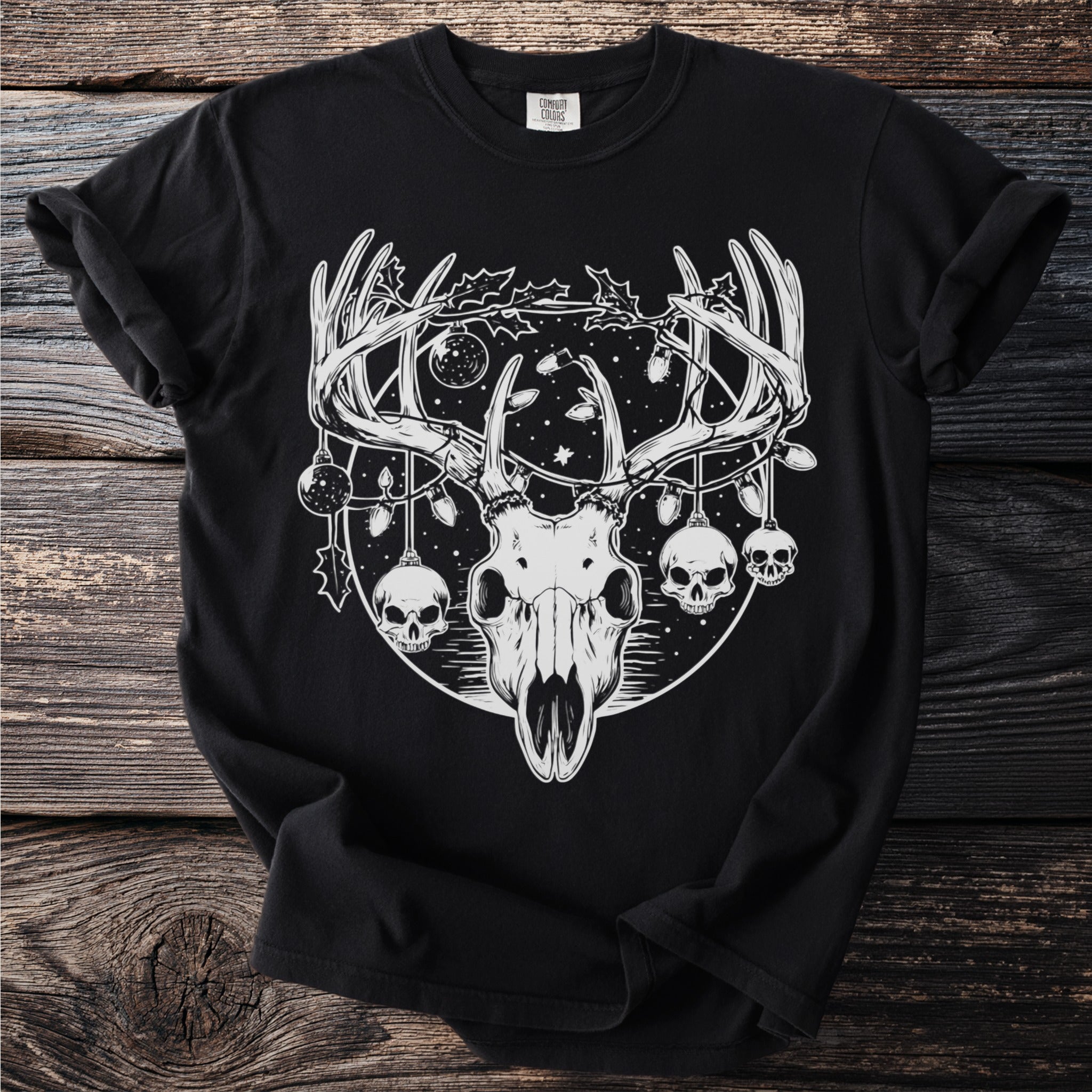 Black t-shirt with deer skull, skulls, and Christmas lights graphic.