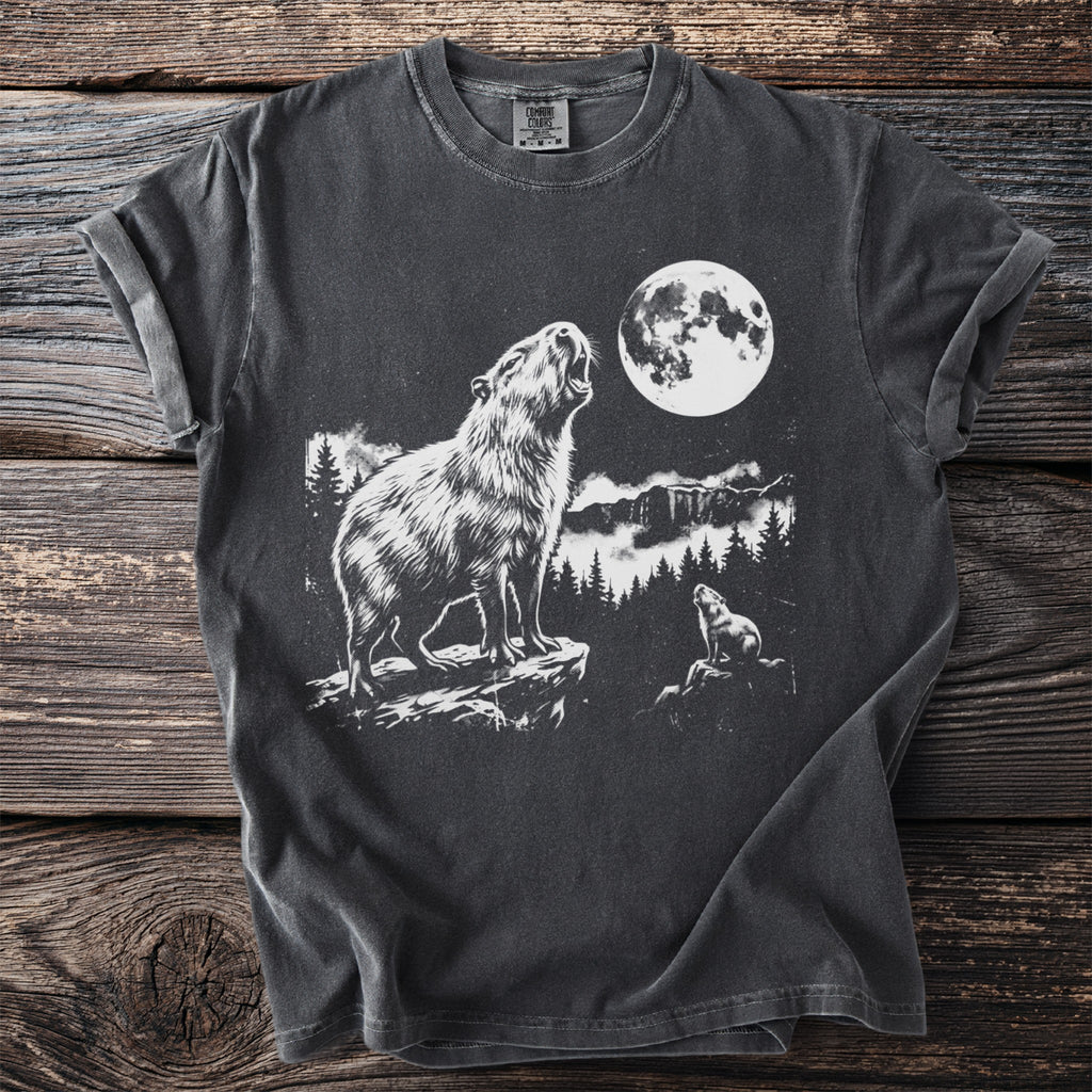Dark t-shirt with white graphic of a capybara howling at the moon.