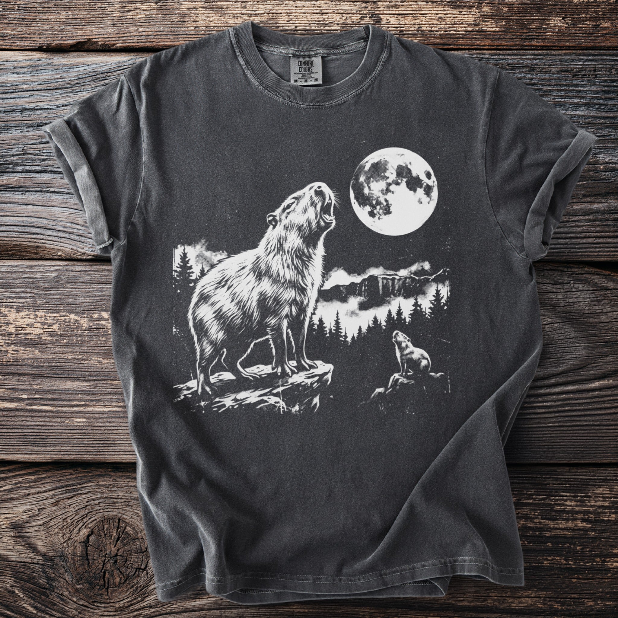 Dark t-shirt with white graphic of a capybara howling at the moon.
